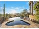 Stunning infinity pool overlooking desert landscape, including a spa and stone surround at 29308 N 108Th N Pl, Scottsdale, AZ 85262