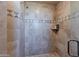 Tiled walk-in shower featuring decorative accent tiles and a glass door at 29308 N 108Th N Pl, Scottsdale, AZ 85262