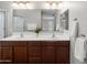 Bathroom featuring a double sink vanity with a large mirror and decorative lights at 2941 N Evergreen St, Buckeye, AZ 85396