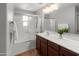 Bright bathroom features a large vanity, a shower over tub, and sleek modern finishes at 2941 N Evergreen St, Buckeye, AZ 85396