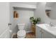 Cozy half bathroom featuring modern fixtures, neutral color scheme, and wood-look flooring at 2941 N Evergreen St, Buckeye, AZ 85396