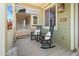Charming front porch featuring rocking chairs, throw pillows, and view of neighborhood at 2941 N Evergreen St, Buckeye, AZ 85396