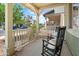 Charming front porch featuring rocking chairs, throw pillows, and view of neighborhood at 2941 N Evergreen St, Buckeye, AZ 85396