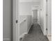 Upstairs hallway leading to bedrooms with carpeted floors and white trim at 2941 N Evergreen St, Buckeye, AZ 85396