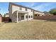 View of the house with covered patio and large backyard at 30271 W Crittenden Ln, Buckeye, AZ 85396