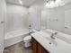 Full bathroom with a tub and shower combo, white vanity, and chrome fixtures at 30271 W Crittenden Ln, Buckeye, AZ 85396