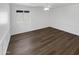 Bedroom with hardwood floors, white trim, a ceiling fan and natural light from a window at 30271 W Crittenden Ln, Buckeye, AZ 85396