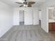 Bedroom with neutral carpet offers an open closet and adjacent bathroom at 30271 W Crittenden Ln, Buckeye, AZ 85396