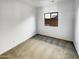 Clean bedroom with a neutral carpet, simple window and electrical outlets on the wall at 30271 W Crittenden Ln, Buckeye, AZ 85396
