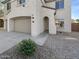 Beautiful stucco home with three car garage, a walkway leading to the front door, and desert landscaping at 30271 W Crittenden Ln, Buckeye, AZ 85396