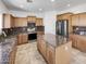 Modern kitchen features granite countertops, stainless steel appliances, and wood cabinets at 30271 W Crittenden Ln, Buckeye, AZ 85396