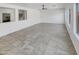 Bright living room with neutral tile flooring and a ceiling fan at 30271 W Crittenden Ln, Buckeye, AZ 85396