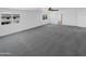 Bright loft area with plush gray carpeting, neutral walls, natural light and an overhead ceiling fan at 30271 W Crittenden Ln, Buckeye, AZ 85396