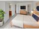 Main bedroom featuring neutral colors, a ceiling fan, and ensuite bathroom and walk-in closet access at 30271 W Crittenden Ln, Buckeye, AZ 85396