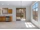 Bright kitchen and dining area with light wood cabinets, stainless steel appliances, and sliding glass door access to the backyard at 3531 N Sericin --, Mesa, AZ 85215