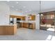 Open kitchen with stainless steel appliances, wooden cabinets, an island, and sliding glass doors to the outdoor area at 3531 N Sericin --, Mesa, AZ 85215