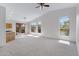 Spacious living room with neutral carpet, vaulted ceilings, and large windows with a view of the backyard at 3531 N Sericin --, Mesa, AZ 85215