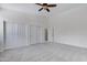 Main bedroom with neutral carpet flooring, a ceiling fan, a double door closet and access to a hallway at 3531 N Sericin --, Mesa, AZ 85215