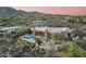 Expansive aerial view of luxury home featuring a stunning pool, putting green, and mountain views at 41611 N 113Th Pl, Scottsdale, AZ 85262