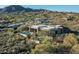 Picturesque aerial view showcasing a desert home with a pool, putting green, and natural surroundings at 41611 N 113Th Pl, Scottsdale, AZ 85262