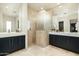 Well-lit bathroom featuring dual sinks, modern vanity, walk-in shower, and contemporary fixtures at 41611 N 113Th Pl, Scottsdale, AZ 85262