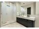 Elegant bathroom featuring tiled shower with glass enclosure and a modern vanity at 41611 N 113Th Pl, Scottsdale, AZ 85262