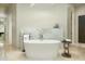 Modern bathroom with freestanding tub, marble accents, and contemporary fixtures at 41611 N 113Th Pl, Scottsdale, AZ 85262