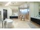 Bright bathroom featuring dual vanities, soaking tub, walk-in shower, and sleek modern design at 41611 N 113Th Pl, Scottsdale, AZ 85262