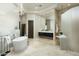 Elegant bathroom with freestanding tub, walk-in shower, modern lighting, and stylish vanity at 41611 N 113Th Pl, Scottsdale, AZ 85262