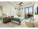 Cozy bedroom with a queen bed, neutral tones, ceiling fan, and natural light from windows at 41611 N 113Th Pl, Scottsdale, AZ 85262