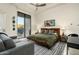 Inviting bedroom featuring a king bed, contemporary art, and a large sliding glass door at 41611 N 113Th Pl, Scottsdale, AZ 85262