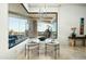 Dining area featuring modern furnishings, stylish lighting, and a picturesque view of the outdoor scenery at 41611 N 113Th Pl, Scottsdale, AZ 85262