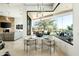 Open-concept dining area with modern light fixture and expansive windows showcasing the outdoor living area at 41611 N 113Th Pl, Scottsdale, AZ 85262
