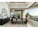 Stylish dining room with modern table, large window, and view of outdoor space at 41611 N 113Th Pl, Scottsdale, AZ 85262