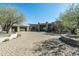 Beautiful single story home featuring a brick driveway, three-car garage, and desert landscaping at 41611 N 113Th Pl, Scottsdale, AZ 85262