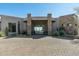 Beautiful front exterior with stone accents, desert landscaping, and paver driveway creates inviting curb appeal at 41611 N 113Th Pl, Scottsdale, AZ 85262