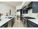 Well-lit kitchen with stainless steel appliances, modern countertops, and convenient access to adjoining rooms at 41611 N 113Th Pl, Scottsdale, AZ 85262