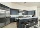 Modern kitchen showcasing sleek cabinetry, stainless steel appliances, and a spacious island with bar seating at 41611 N 113Th Pl, Scottsdale, AZ 85262