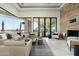 Cozy living room features a stone fireplace, comfortable seating, and natural light at 41611 N 113Th Pl, Scottsdale, AZ 85262