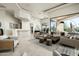 Open-concept living area with bar, comfortable seating, and floor-to-ceiling windows at 41611 N 113Th Pl, Scottsdale, AZ 85262