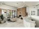 Spacious, light-filled living room with fireplace, marble bar, and comfortable seating at 41611 N 113Th Pl, Scottsdale, AZ 85262