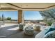 Comfortable outdoor lounge area with views of the pool and desert landscape at 41611 N 113Th Pl, Scottsdale, AZ 85262
