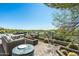 Relaxing outdoor patio featuring comfortable seating, a modern fire pit, and desert views at 41611 N 113Th Pl, Scottsdale, AZ 85262