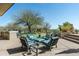 Large outdoor patio with comfortable seating, a built-in grill, and a putting green for entertainment at 41611 N 113Th Pl, Scottsdale, AZ 85262