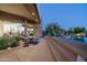 Gorgeous patio area with an outdoor seating area, pool and steps leading up to outdoor seating on the property at 41611 N 113Th Pl, Scottsdale, AZ 85262