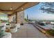 Elegant covered patio with stone accents and comfortable seating for outdoor relaxation and entertainment at 41611 N 113Th Pl, Scottsdale, AZ 85262