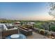 Inviting outdoor patio space with a fire pit, comfortable seating, and golf course view at 41611 N 113Th Pl, Scottsdale, AZ 85262