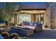 Outdoor patio with modern fire pit and seating. Views of the cactus-filled yard and building at 41611 N 113Th Pl, Scottsdale, AZ 85262