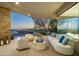 Spacious covered patio with cozy seating arrangements and open views of the outdoor landscape at 41611 N 113Th Pl, Scottsdale, AZ 85262