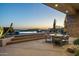Inviting outdoor patio featuring comfortable seating, a fireplace, and stunning sunset views at 41611 N 113Th Pl, Scottsdale, AZ 85262